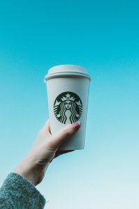 Personal holding Starbucks cup show the professional business image of Starbucks
