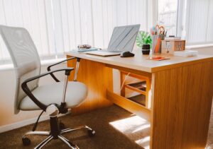 Office desk and chair by a window in a successful business