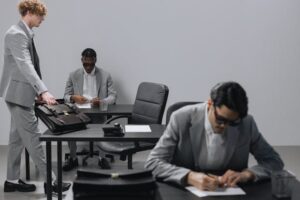 picture depicts men in grey suits protecting your business