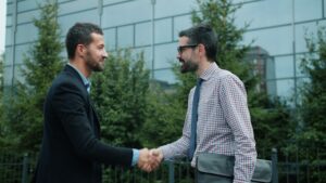 Two men shaking hands after business acqusition