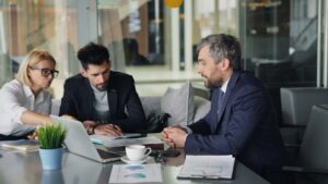 Global communication between business colleagues sitting at table working