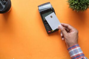 Person using a credit card at a payment terminal